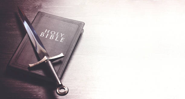 Ready to Fight Our Battles-Bible and a Sword on a Dark Wooden Table