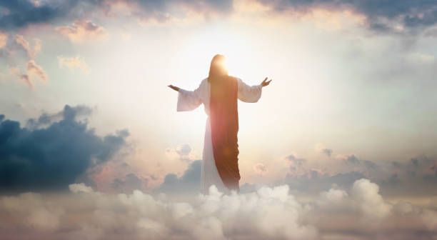 THE NATURE OF JESUS CHRIST- The resurrected Jesus Christ ascending to heaven above the bright light sky and clouds.