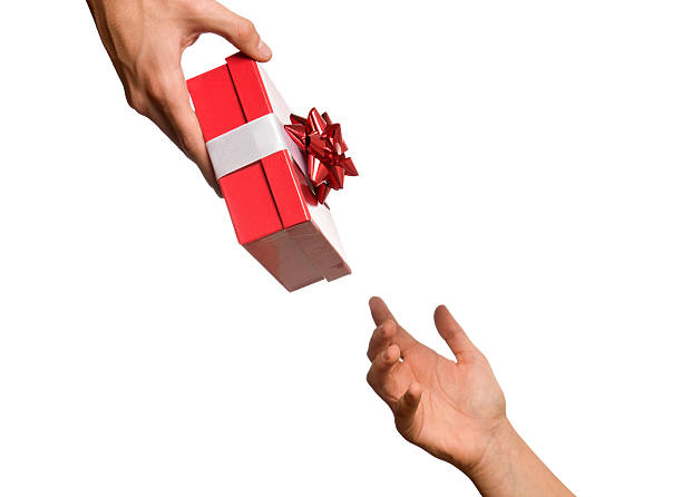 THE INCREDIBLE GIFT OF GOD- a male hand giving a red gift box to a female hand