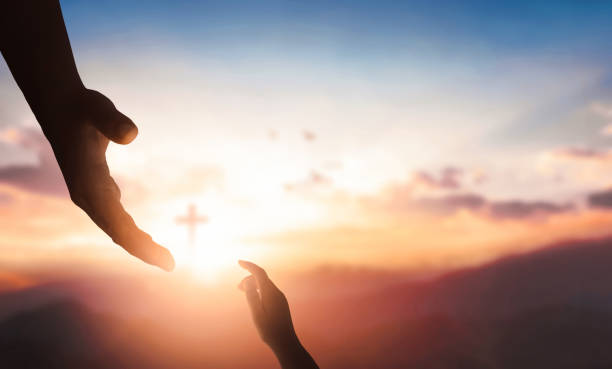 THE SOVEREINTY OF GOD- Silhouettes of hands reaching out for hope and supporting each other on sunset background.