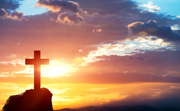 Religious cross on the hill at sunset.